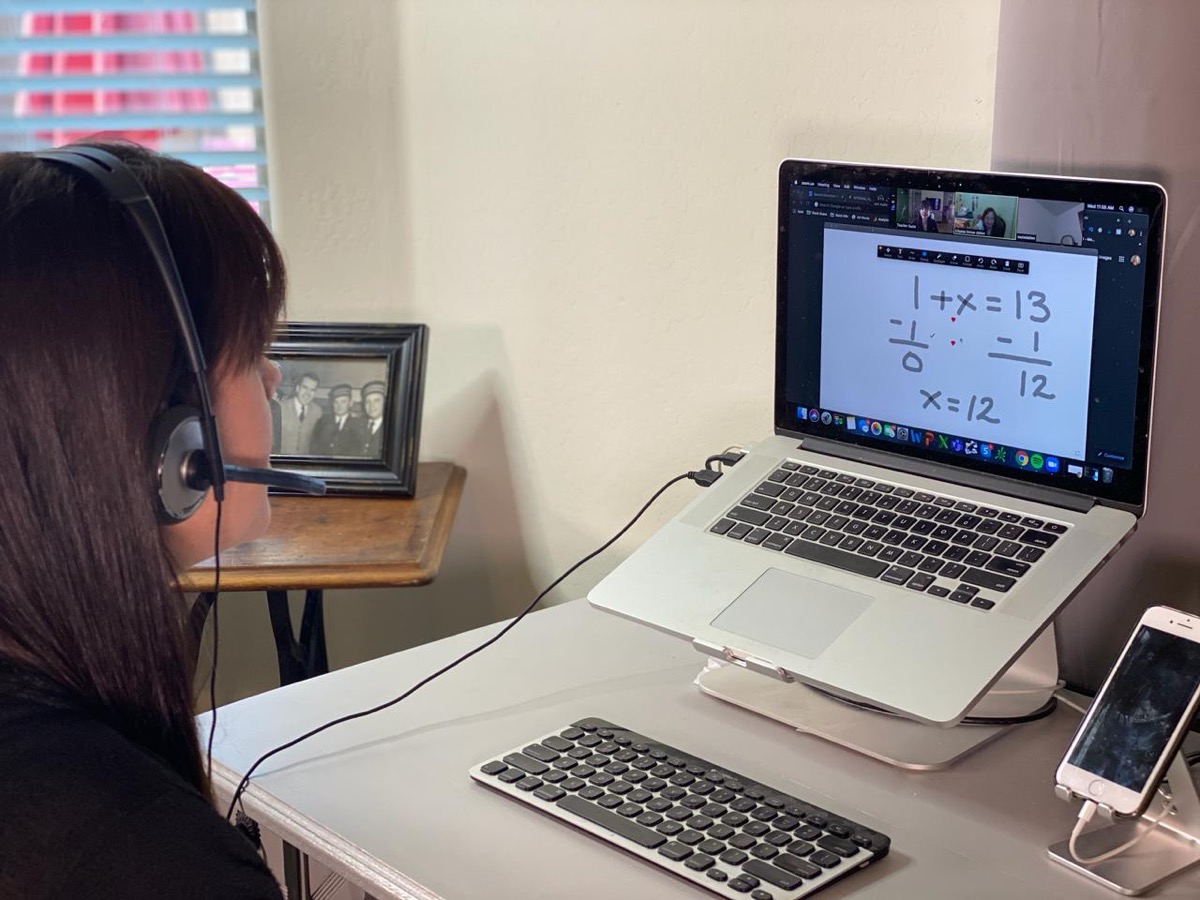 A tutor working one-to-one with a student in an online session
